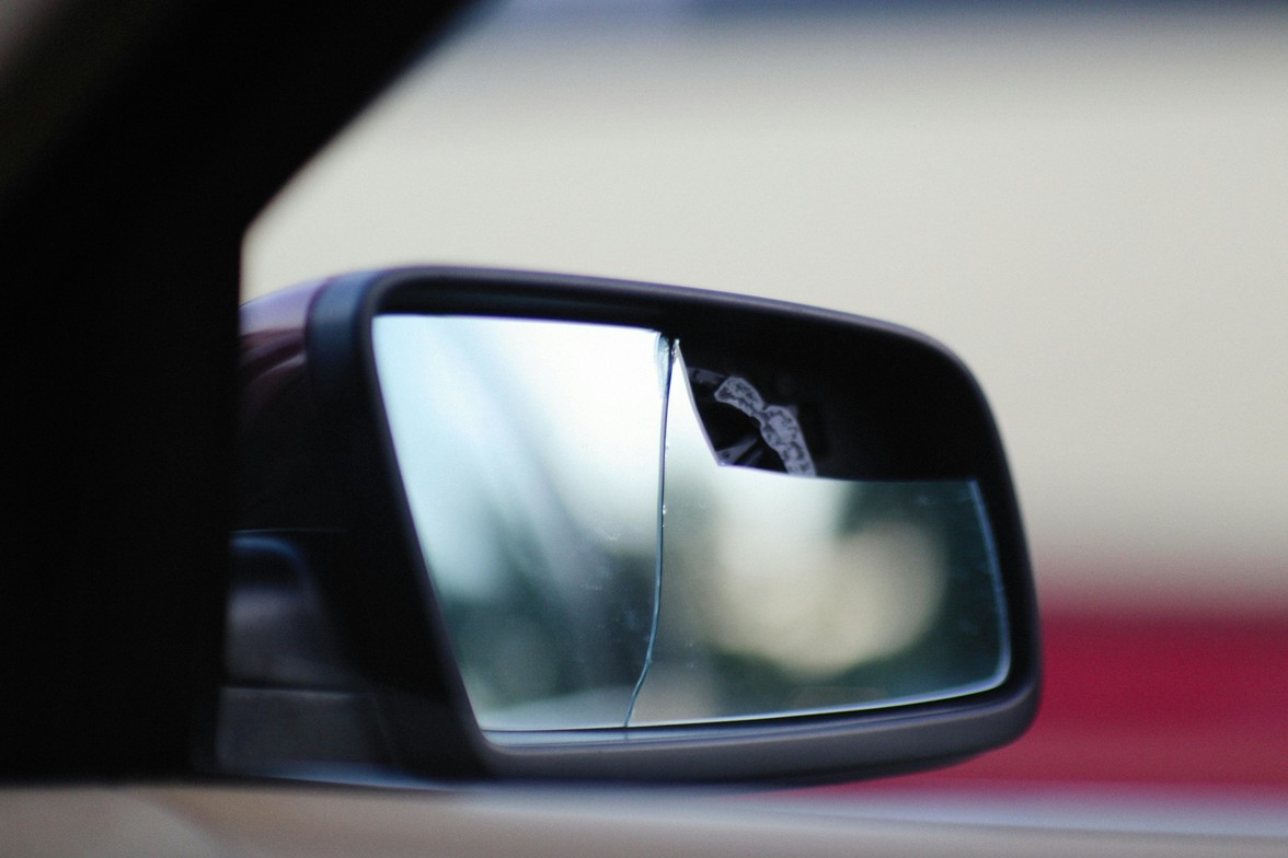 Broken side view mirror of a car to promote Cache Valley Chiropractic personal injury care